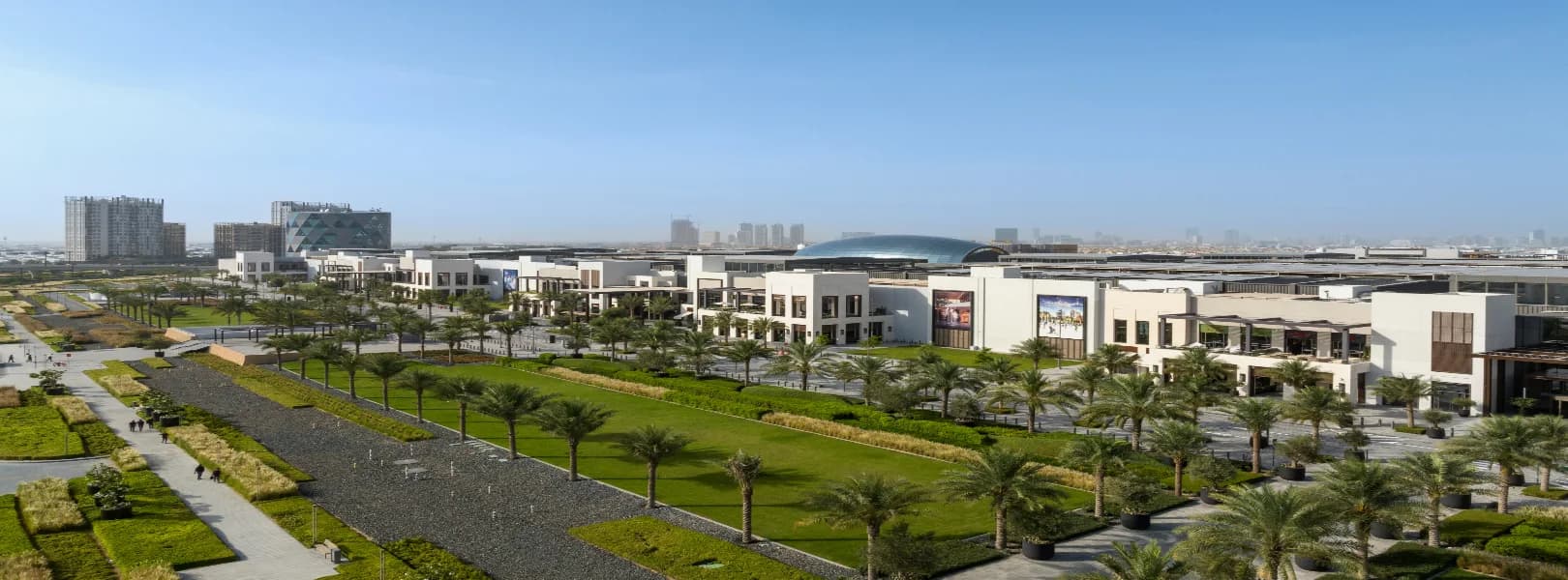 Aerial view of Dubai Hills Mall and the palm-lined boulevard park